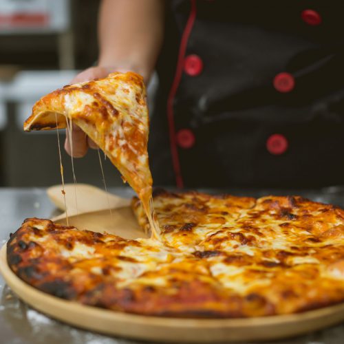 chef making pizza at kitchen